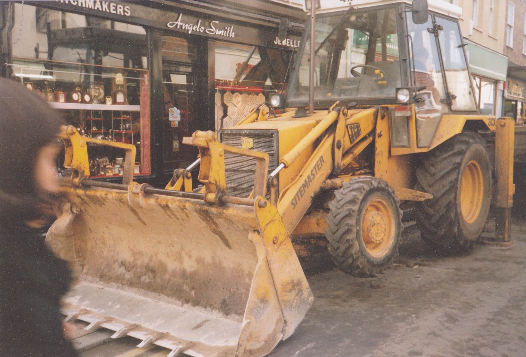 A yellow digger outside Angelo Smith shop
