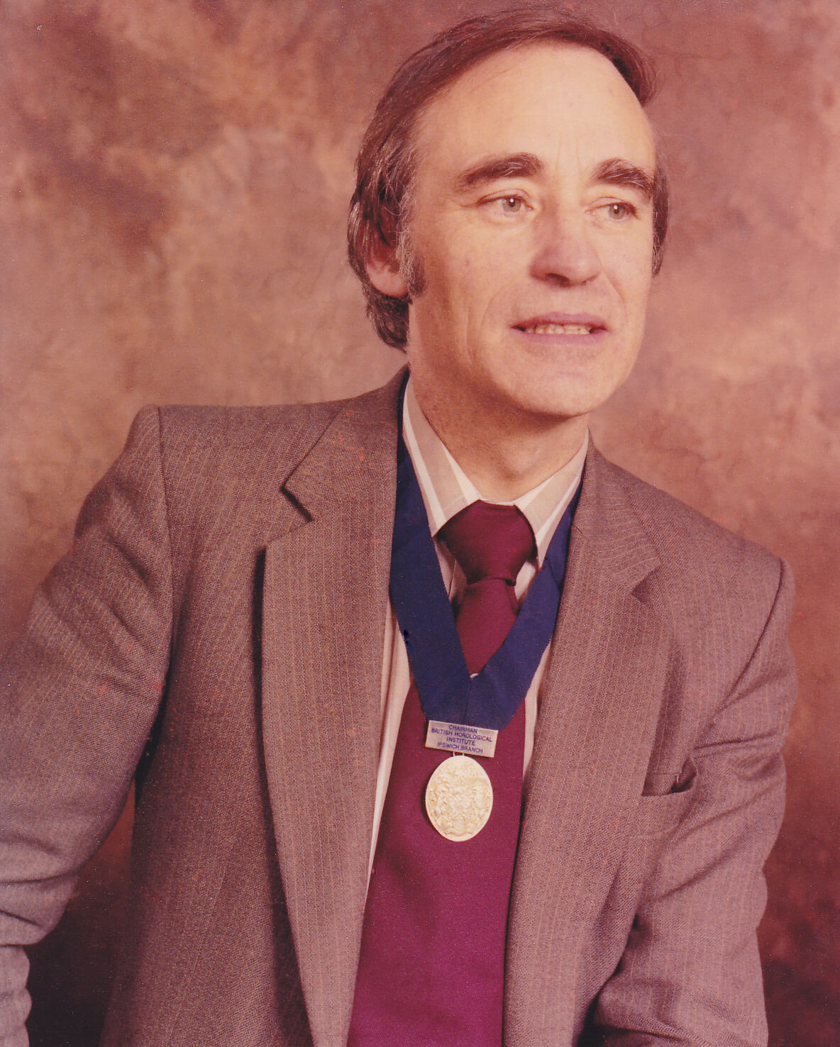 A portrait of Peter Smith wearing his British Horological Institue medllion