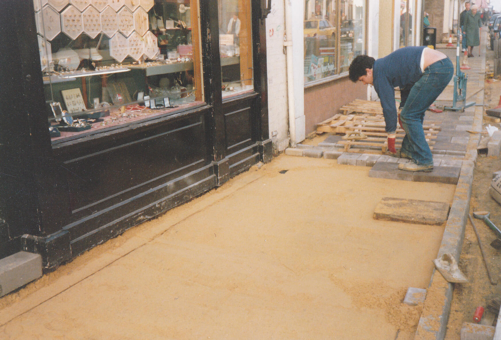 A man re-paves the street outside Angelo Smith