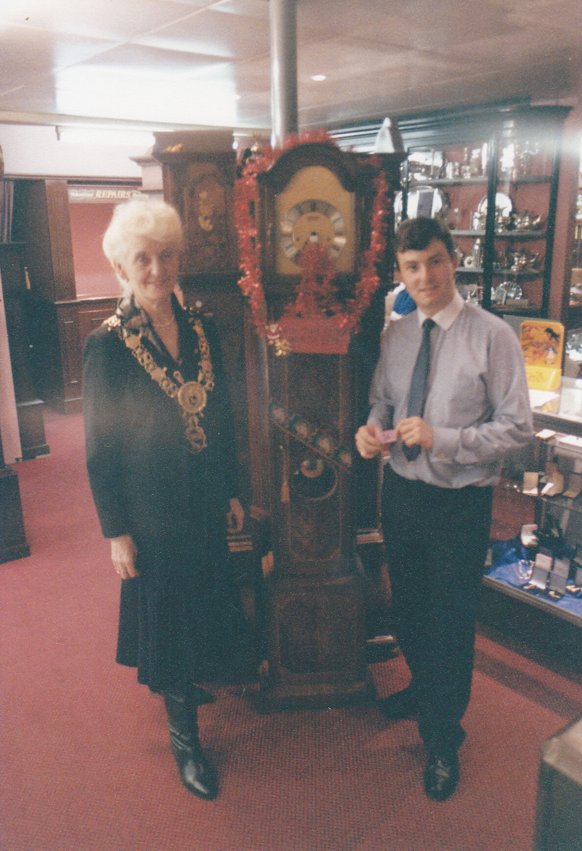 A mayor and John Hume stand with a grandfather clock